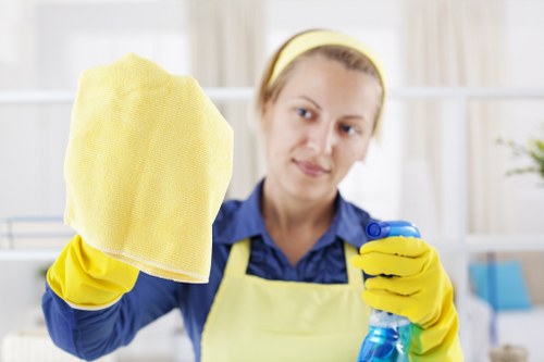 Professional cleaners maintaining a shared office area in E14